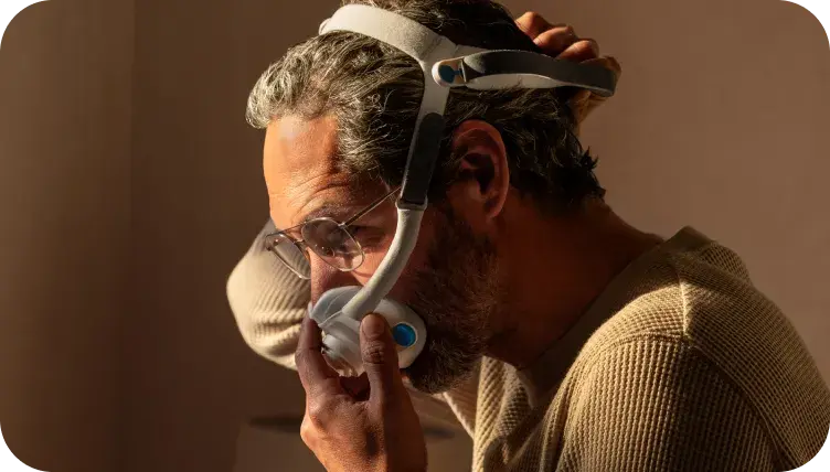 Sleeping man with mask on pillow