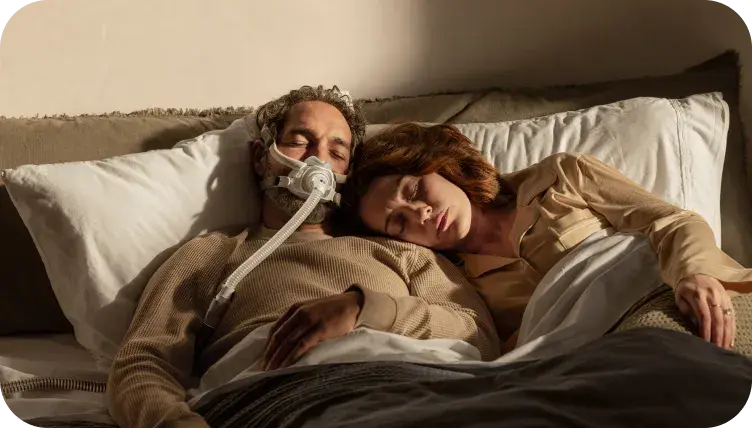 Sleeping man with mask on pillow zoomed in